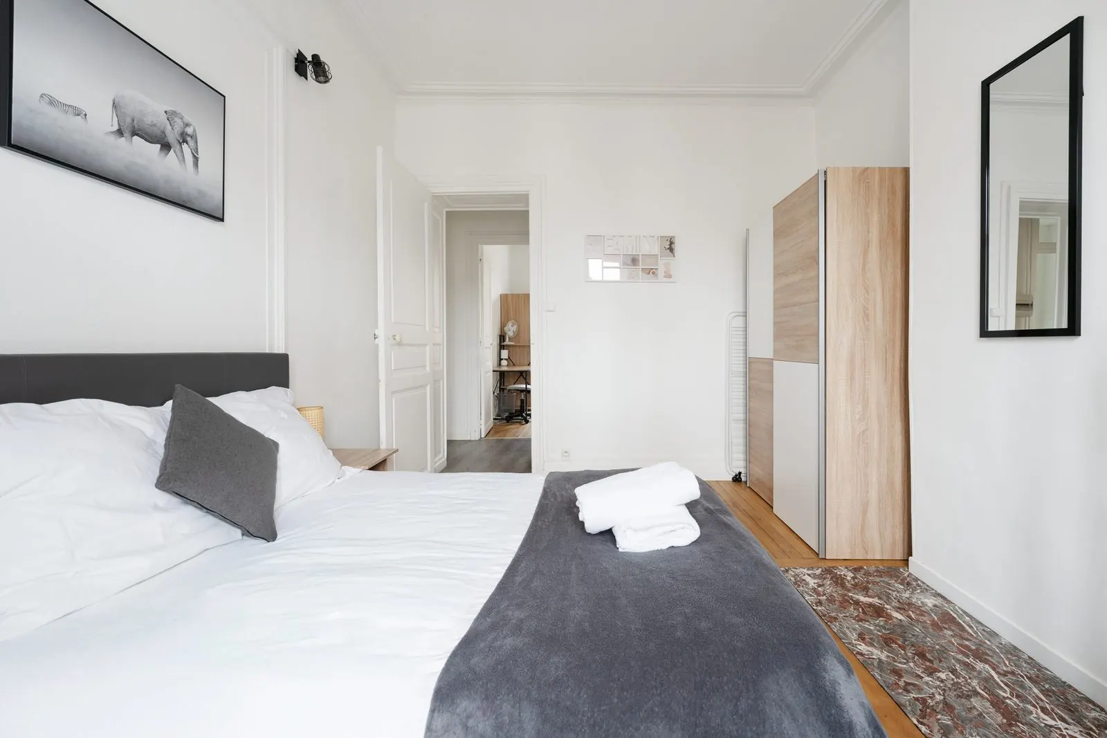 La Fabrique, furnished apartment, Nancy: bedroom with grey throw and wardrobe