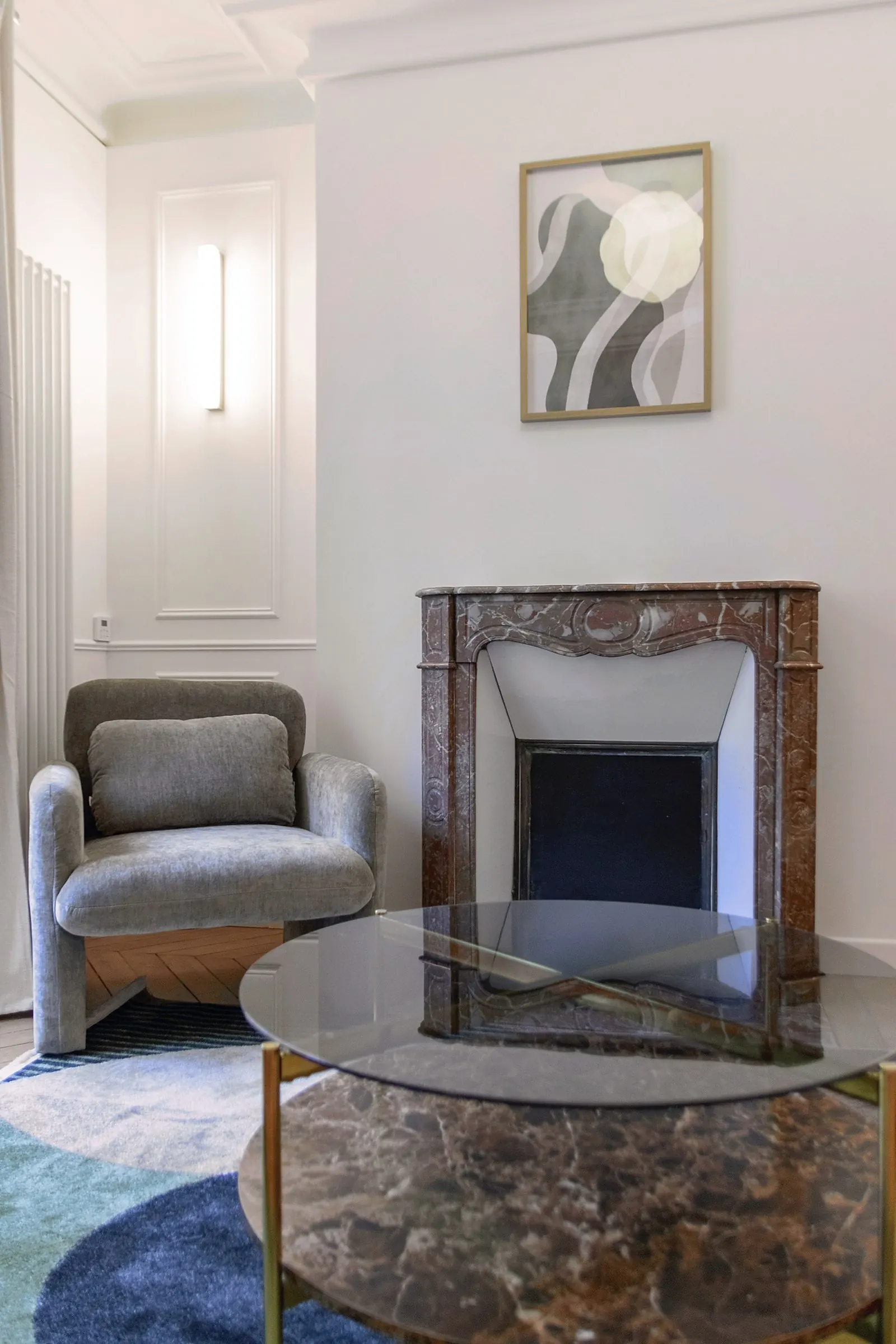 Le Gustave, furnished apartment, Paris 7th: marble fireplace and armchair